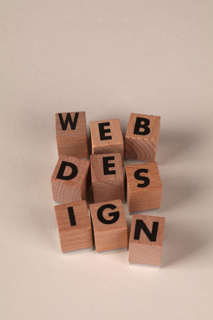 Wooden blocks laid out to spell Web Design. Ideal for themes centered on creative digital content.